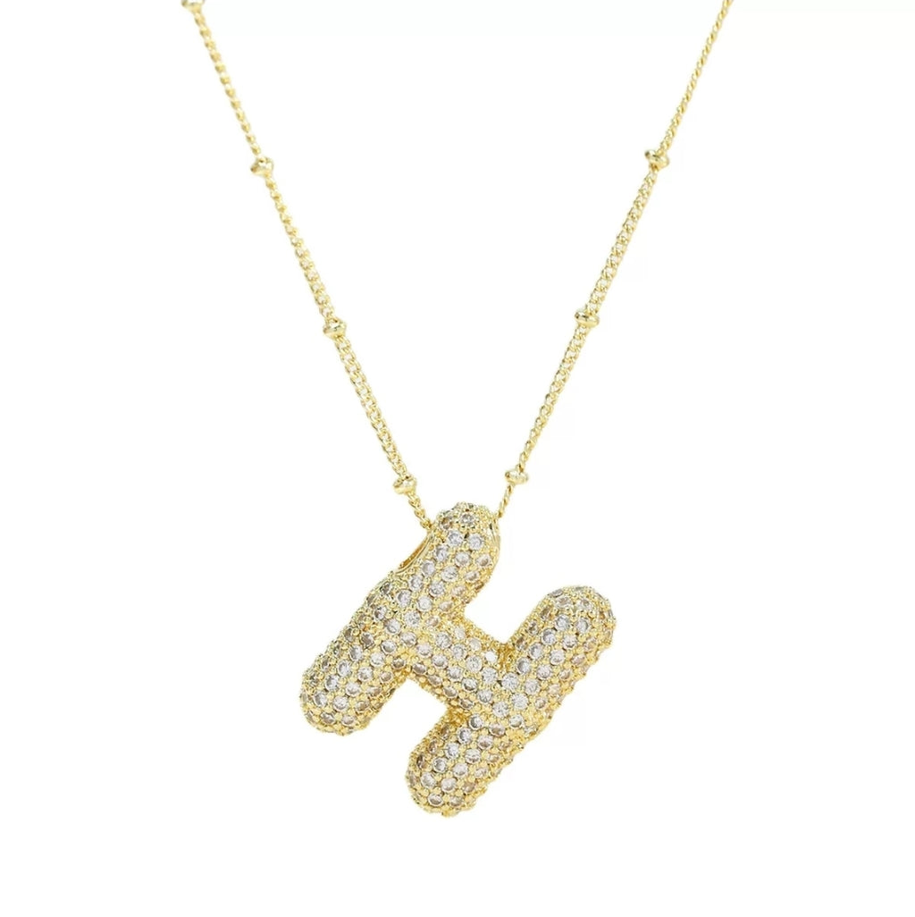 Simple initial necklace with the letter H from Glitze Accessories featuring a delicate chain and minimalist design.