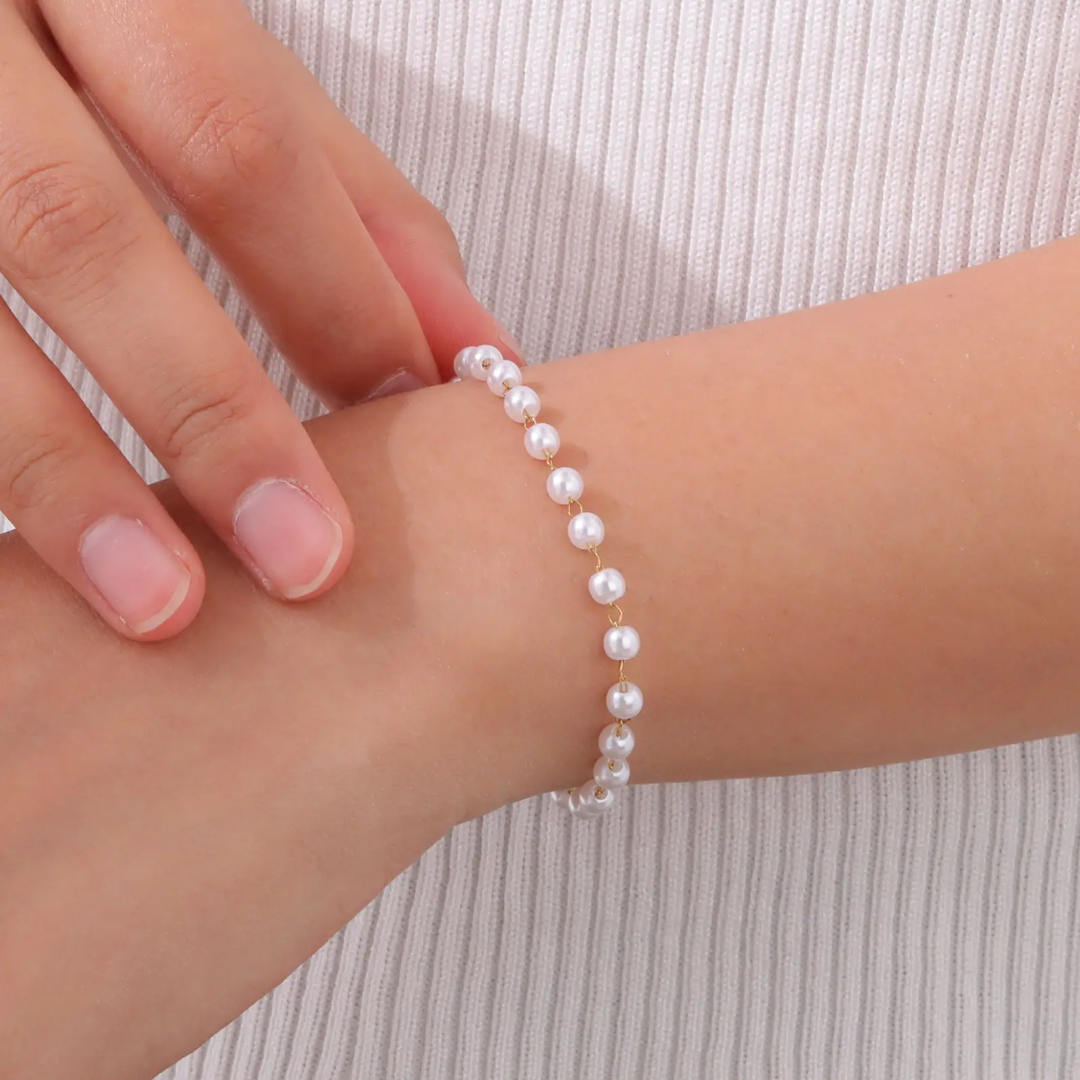 Elegant pearl bracelet by Glitze Accessories featuring white pearls and a delicate clasp on a soft background.
