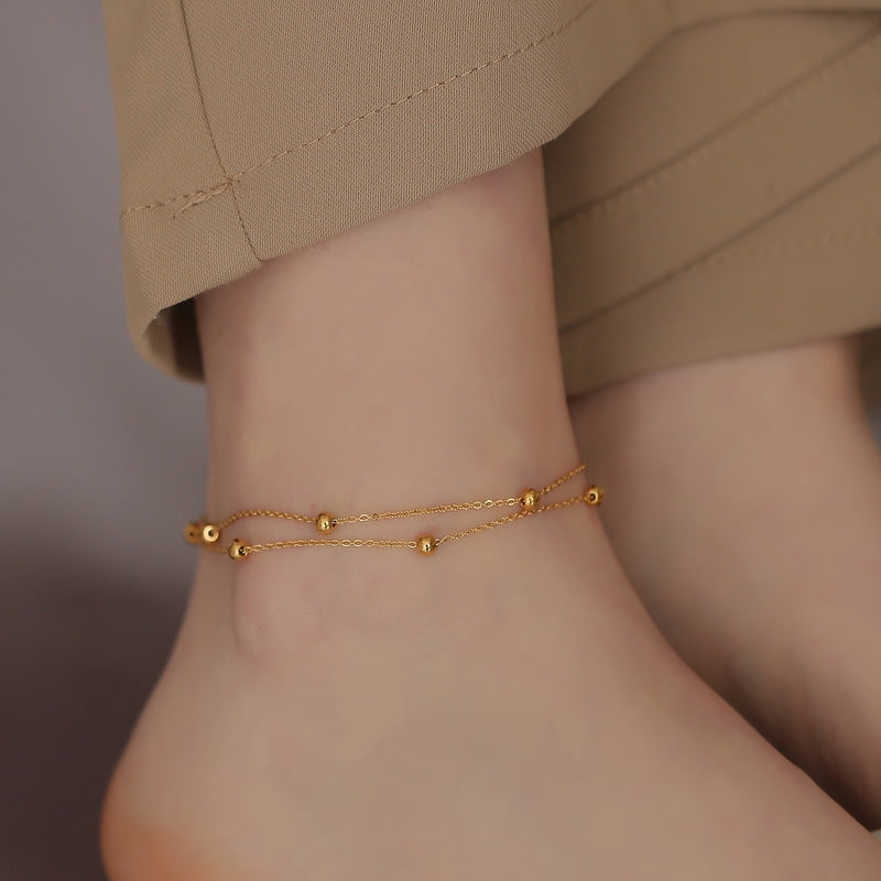 Simple silver Vera anklet by Glitze Accessories featuring a delicate chain design on an ankle.