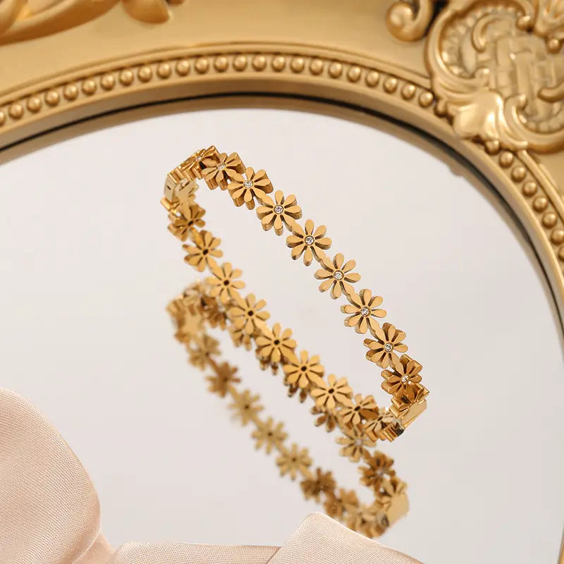 Flovera earrings by Glitze Accessories featuring floral design with gold-tone accents and butterfly clasp.